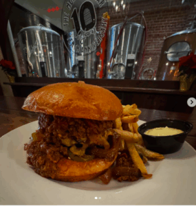 monks cellar burger texas chili, pickled jalapenos, cheddar cheese and grilled onions and a brioche bun