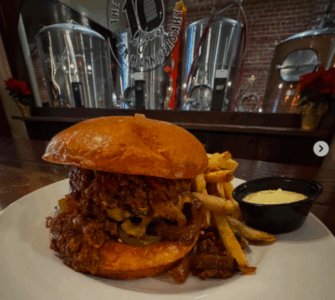 monks cellar burger texas chili, pickled jalapenos, cheddar cheese and grilled onions and a brioche bun