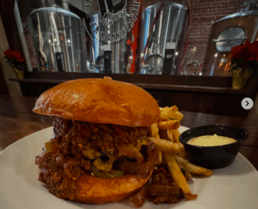 monks cellar burger texas chili, pickled jalapenos, cheddar cheese and grilled onions and a brioche bun
