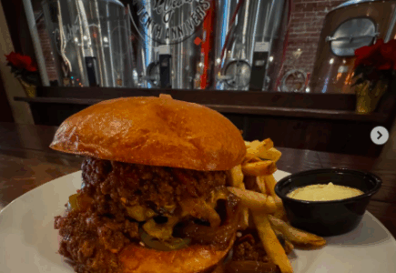 monks cellar burger texas chili, pickled jalapenos, cheddar cheese and grilled onions and a brioche bun