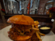 monks cellar burger texas chili, pickled jalapenos, cheddar cheese and grilled onions and a brioche bun