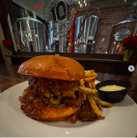 monks cellar burger texas chili, pickled jalapenos, cheddar cheese and grilled onions and a brioche bun